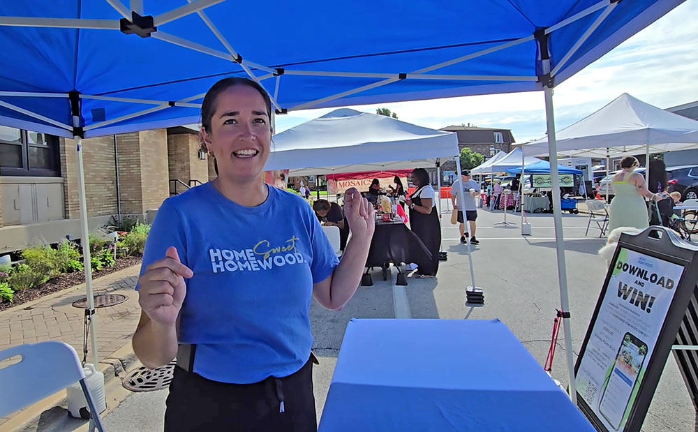 Homewood Events Manager Marla Youngblood describes the market's new feature, themes, which she hopes to expand on next year. The market continues through Oct. 11. (Eric Crump/H-F Chronicle)