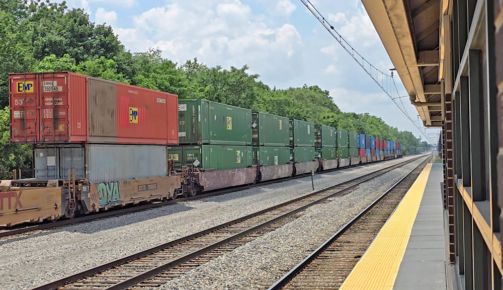 Intermodal rail cars move past Flossmoor train station on July 15. Homewood and Flossmoor were born as railroad towns and continue to be part of the busiest rail hub in the nation. (Eric Crump/H-F Chronicle)