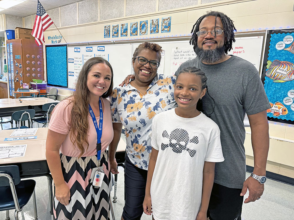 Teacher Brook Sanders, left, welcomed her fifth grade student Ciara Wilson and her parents, Cathy and Sidon Wilson, during Churchill School's open house. Sidon Wilson also attended Churchill School. (Marilyn Thomas/H-F Chronicle)