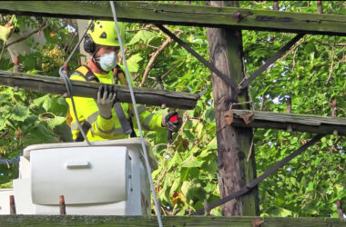 Dave Becker removes a cross arm from one of the three telegraph poles a Flossmoor Public Works crew removed Wednesday, Sept. 10. Several cross arms were given to local historians as artifacts. (Eric Crump/H-F Chronicle)