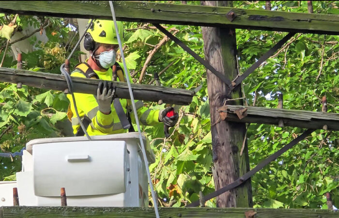 Dave Becker removes a cross arm from one of the three telegraph poles a Flossmoor Public Works crew removed Wednesday, Sept. 10. Several cross arms were given to local historians as artifacts. (Eric Crump/H-F Chronicle)