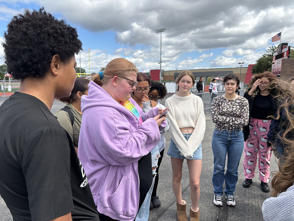 Molly Stapleton, a senior at Homewood-Flossmoor High, shares information about a 10-year-old who died by gun violence. About 30 students gathered on campus as part of a national Students Demand Action rally demanding an end to gun violence. (Marilyn Thomas/H-F Chronicle)