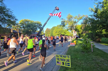 Runners head west on Flossmoor Road past Flossmoor village hall at the start of the Hidden Gem Half Marathon. (Eric Crump/H-F Chronicle)