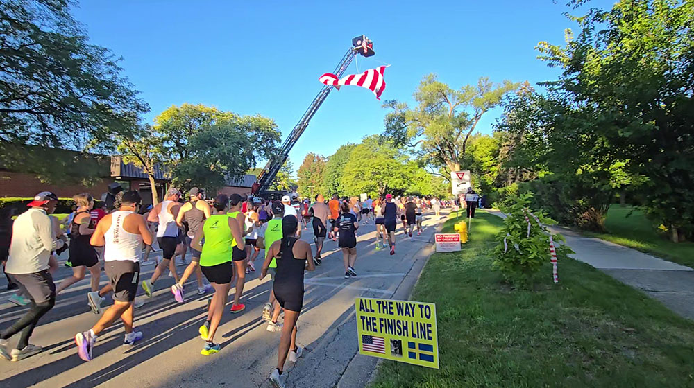 Runners head west on Flossmoor Road past Flossmoor village hall at the start of the Hidden Gem Half Marathon. (Eric Crump/H-F Chronicle)