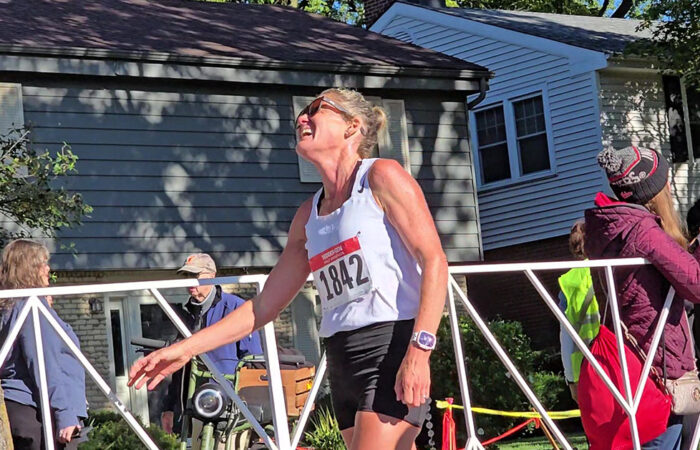 Maria Lindberg smiles after checking her time after crossing the finish line. She took first place among women in the Hidden Gem Half Marathon with a time of 1:15:13. (Eric Crump/H-F Chronicle)