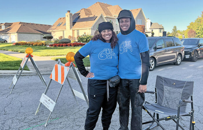 Erika Whittier and her son, Brandon, volunteer as course marshals during the Hidden Gem Half Marathon in Flossmoor. (Nuha Abdessalam/H-F Chronicle)