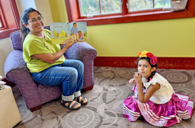 Elena, 6, joins Jessica Cheney for a bilingual story at the library’s first Hispanic Heritage Month event. (Nuha Abdessalam/H-F Chronicle)