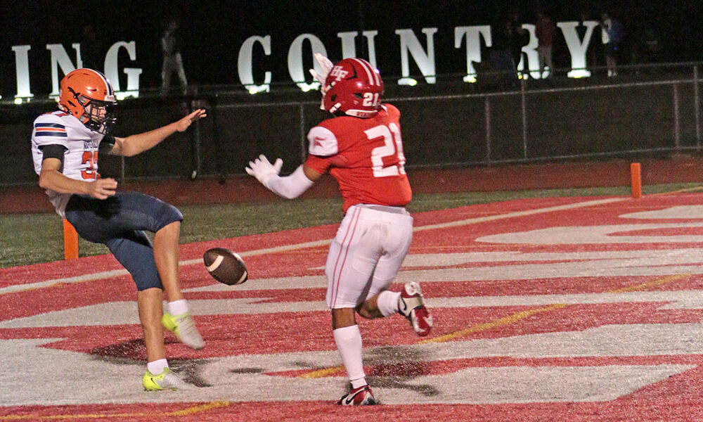 William Bundy (No. 21) breaks through and blocks a punt in the end zone, resulting in a touchdown. (Benjamin Faoro/H-F Chronicle)
