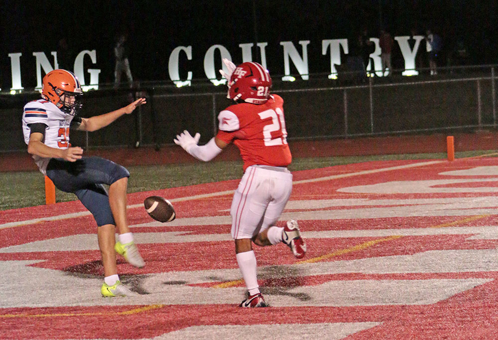 William Bundy (No. 21) breaks through and blocks a punt in the end zone, resulting in a touchdown. (Benjamin Faoro/H-F Chronicle)