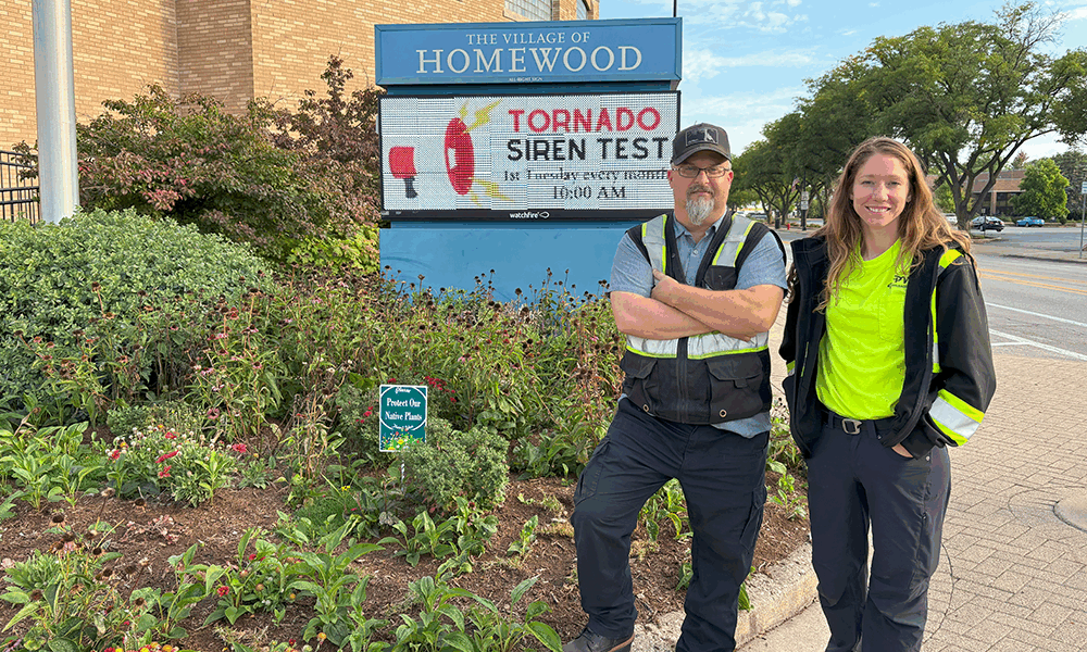Homewood Arborist Bryon Doerr (left) and Homewood Public Works member Katie Becker (right) stand in front of the native species landscape that they planted outside Village Hall. (Summer Kiswani/ H-F Chronicle)