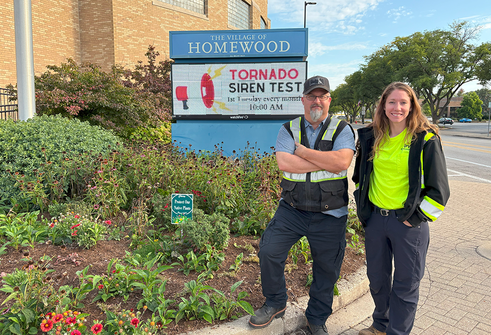 Homewood Arborist Bryon Doerr (left) and Homewood Public Works member Katie Becker (right) stand in front of the native species landscape that they planted outside Village Hall. (Summer Kiswani/ H-F Chronicle)