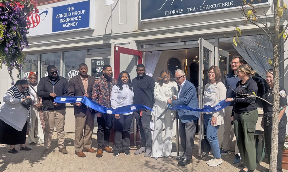 Maison des Fluers owner Lanise Swarn, left, holds the scissors with Homewood Mayor Rich Hofeld and cuts the blue ribbon at the grand opening celebration on Sept. 5. (Nick Ulanowski / H-F Chronicle)