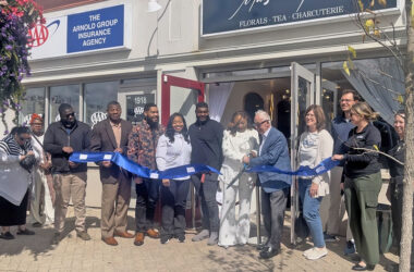 Maison des Fluers owner Lanise Swarn, left, holds the scissors with Homewood Mayor Rich Hofeld and cuts the blue ribbon at the grand opening celebration on Sept. 5. (Nick Ulanowski / H-F Chronicle)