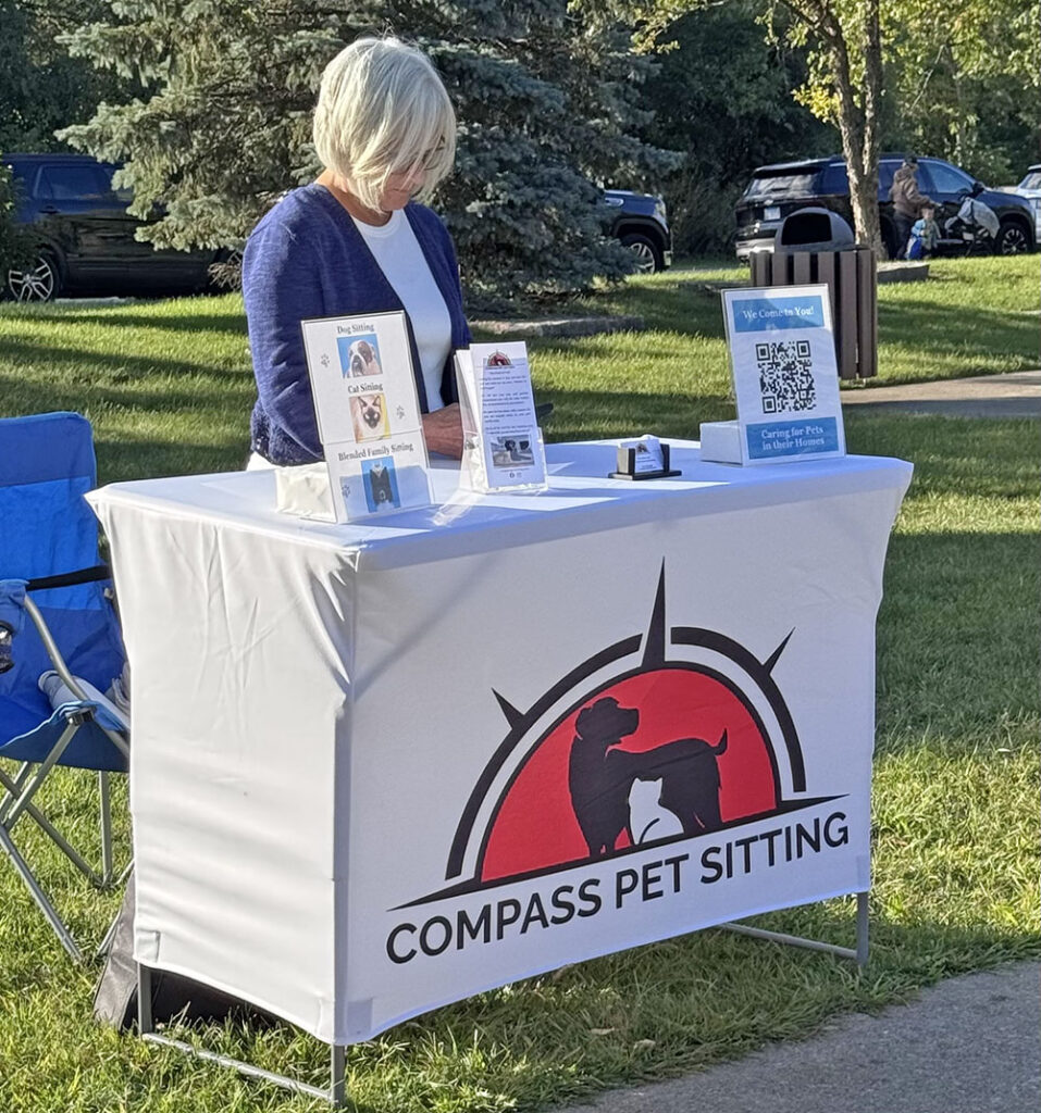 A representative from Compass Pet Sitting stands ready to give information to pet owners at the Pups at the Pad event. (Karen Torme Olson)