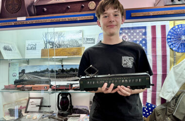 H-F High School sophomore and railroad aficionado Anderson Pries shows off a model of an Illinois Central Railroad (IC) electric passenger car, which currently is displayed with other railroad memorabilia at the Homewood Historical Society museum in the Christian Dorband-Charles Albee Howe building. Anderson is curating a redesigned and expanded Illinois Central exhibit for the museum with HHS Director Megan Tipton. (All photos by Karen Torme Olson)