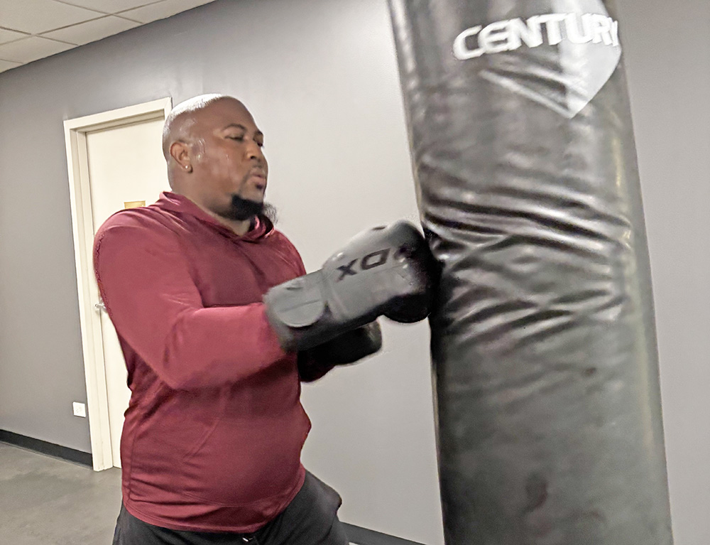 Robert Lane of Flossmoor jabs at the bag during his boxing training session at the H-F Racquet & Fitness Center. (Marilyn Thomas/H-F Chronicle)