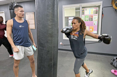 Coach Luis Unzueta watches as Tanisha Cannon of Homewood gets ready to take a swing in the boxing studio at the H-F Racquet & Fitness Center. (Marilyn Thomas/H-F Chronicle)