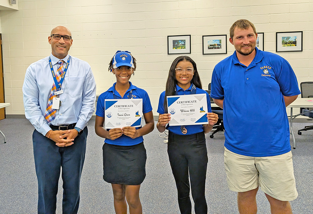 From left, Superintendent Dana Smith stands with IESA State Golf participants Imani Green, Wakana Hill, and Coach Michael Shereyk. (Chris Weber/H-F Chronicle)