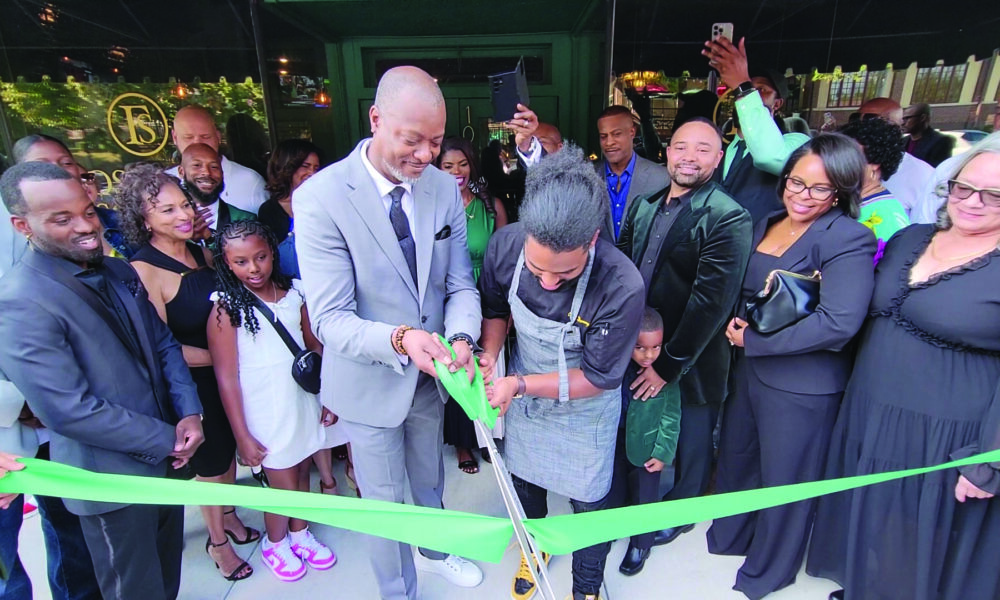 General Manager Mikal Shakir, left, and Executive Chef Daniel Bullock cut the ribbon to mark the opening of Flossmoor Social, a new restaurant in downtown Flossmoor. (Eric Crump/H-F Chronicle)