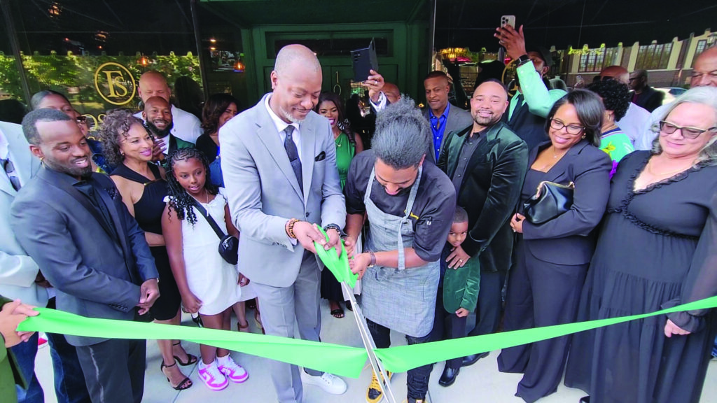 General Manager Mikal Shakir, left, and Executive Chef Daniel Bullock cut the ribbon to mark the opening of Flossmoor Social, a new restaurant in downtown Flossmoor. (Eric Crump/H-F Chronicle)