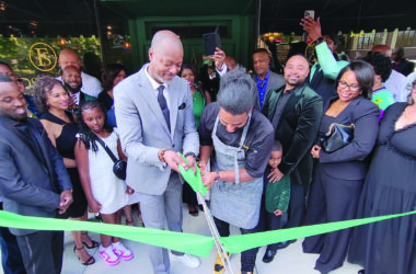 General Manager Mikal Shakir, left, and Executive Chef Daniel Bullock cut the ribbon to mark the opening of Flossmoor Social, a new restaurant in downtown Flossmoor. (Eric Crump/H-F Chronicle)