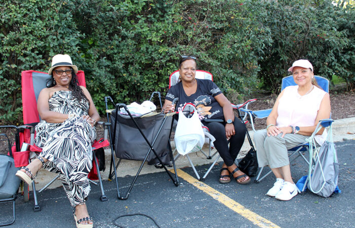 Longtime friends Diane Adamore-Johnson, Veronica Holloway, and Yvette Coats secure their spot for the live music. "We come out every year," one said, making their OAKtoberfest outing an annual tradition. (Nuha Abdessalam/H-F Chronicle)