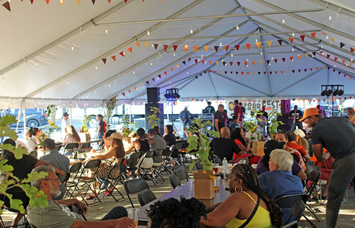 Inside the OAKtoberfest party tent, a crowd enjoys the live performance, food, and beverages as the sun sets on the Flossmoor celebration. (Nuha Abdessalam/H-F Chronicle)