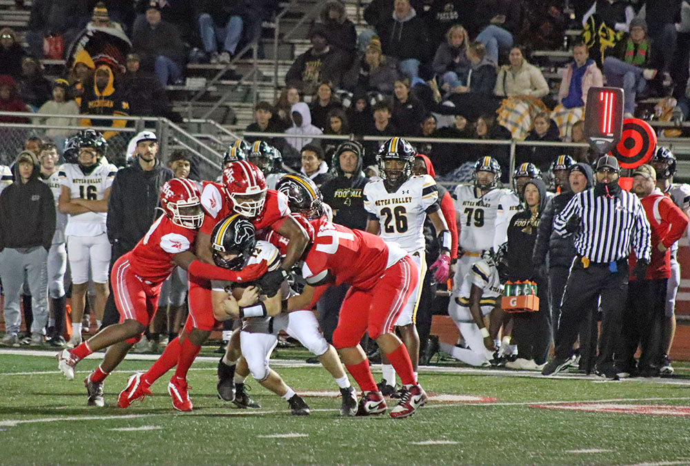 Three Vikings defenders swarm the ball carrier on first down, stalling the Metea Valley offense and ending the drive. (Benjamin Faoro/ HF Chronicle)