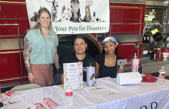 Dr. Coleen Fruin, far left, vet assistant Marisol Munoz and veterinary technician Natalia Taylor at the Homewood Veterinary Care booth. (Nick Ulanowski / H-F Chronicle)