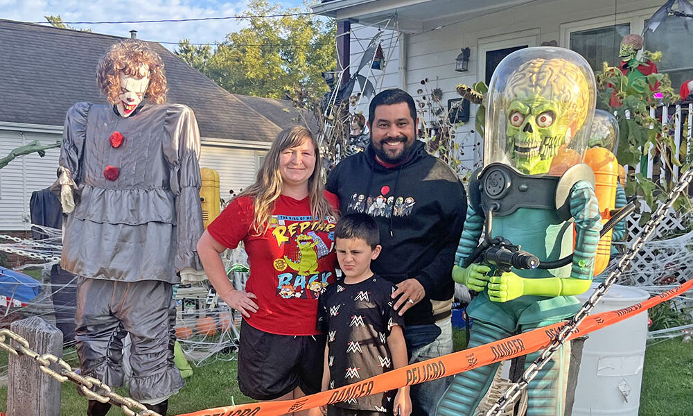 Jimmy Marinez, his wife Alisha and his son Rex in his yard heavily decorated with Halloween decorations at 1735 Ridge Road in Homewood. (Nick Ulanowski / H-F Chronicle)