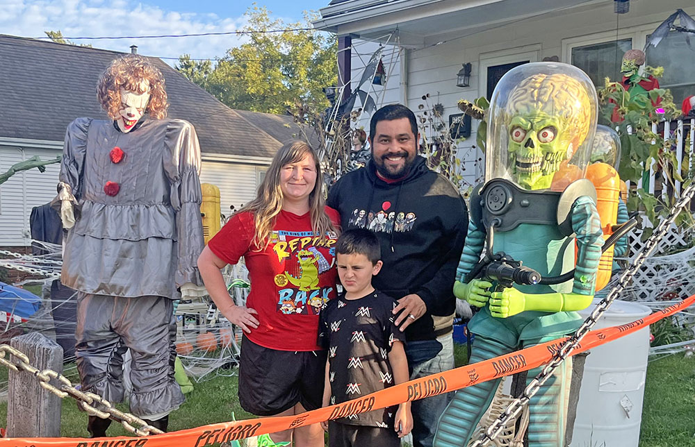 Jimmy Marinez, his wife Alisha and his son Rex in his yard heavily decorated with Halloween decorations at 1735 Ridge Road in Homewood. (Nick Ulanowski / H-F Chronicle)