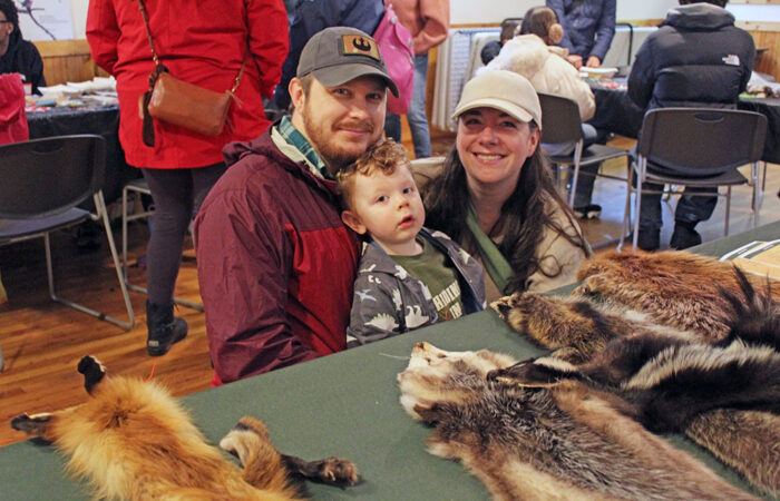 The Kennedy family stops by a wildlife display table during Walk Walton at Izaak Walton Preserve. (Nuha Abdessalam/H-F Chronicle)