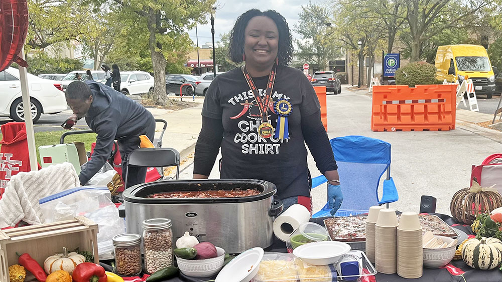 First place winner in the chili cooking contest, Toyia Mcwilliams, at her booth at Homewood Fall Fest. (Nick Ulanowski / H-F Chronicle)