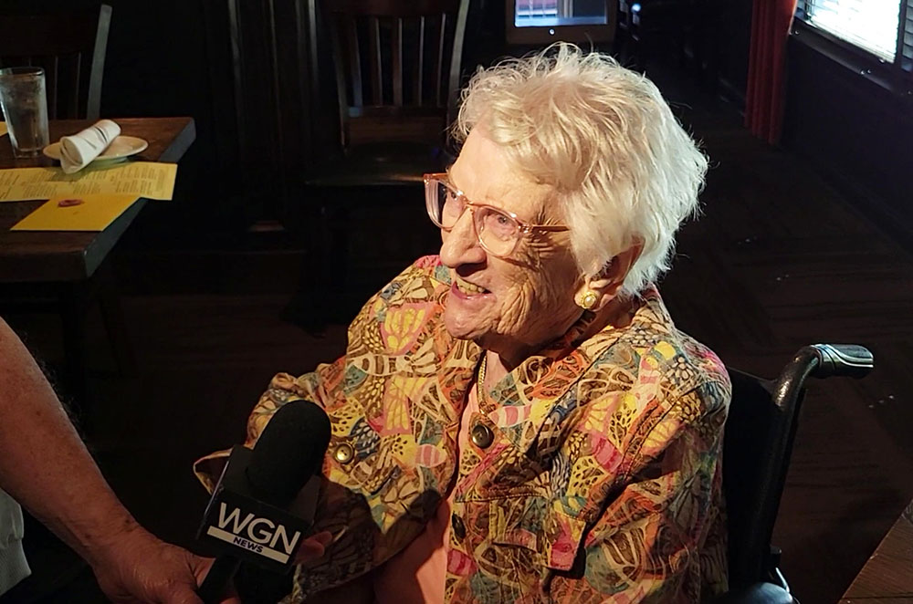 Mary Cantway is interviewed by a WGN TV reporter at her 111th birthday party Sept. 30. (Eric Crump/H-F Chronicle)