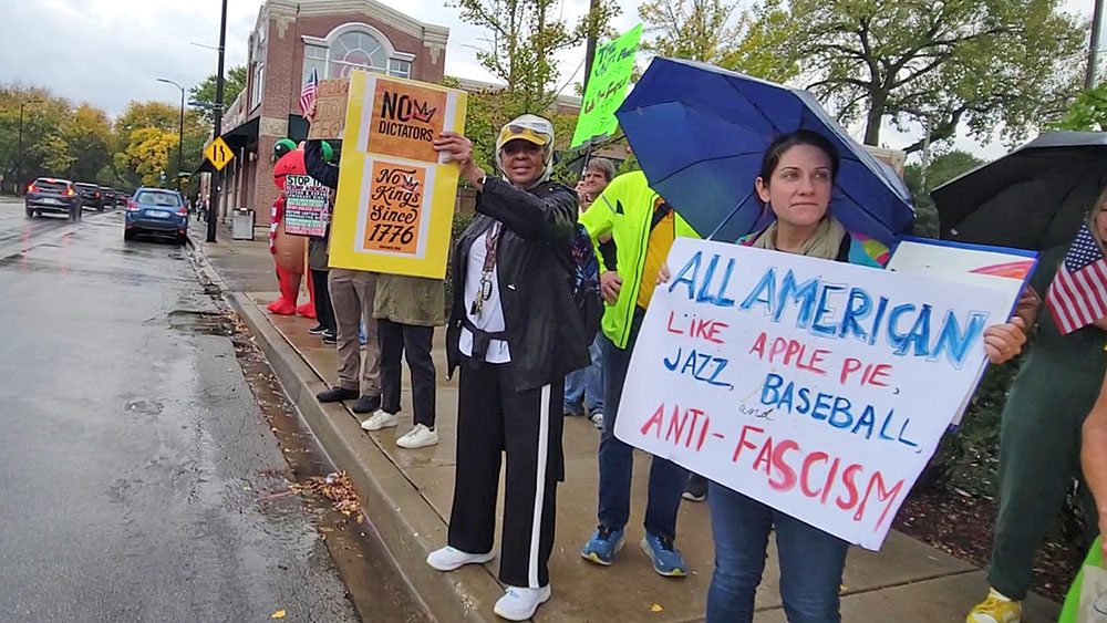 A protester holds a sign that reads, "All American like apple pie, jazz, baseball and anti-fascism" at the No Kings demonstration in Beverly on Oct. 18. (Eric Crump/H-F Chronicle)