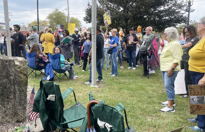 Protesters gather in front to the veteran's memorial to hear the organizers speak at the No Kings protest Oct. 18 in Homewood. (Jamilah Lewis/H-F Chronicle)