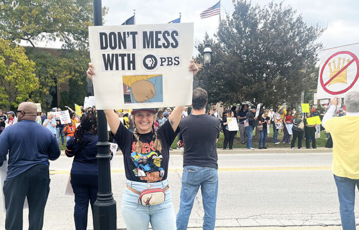 Homewood resident Caroline Kjors holds a sign in support of PBS at the No Kings rally on Oct. 18. (Nick Ulanowski / H-F Chronicle)