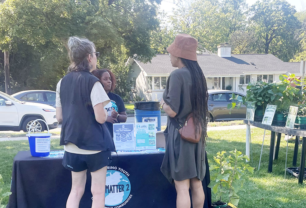 Residents speaking with You Matter 2 founder Destiny Watson at the organization's table during OAKtoberfest Oct. 4. (Jamilah Lewis/H-F Chronicle)