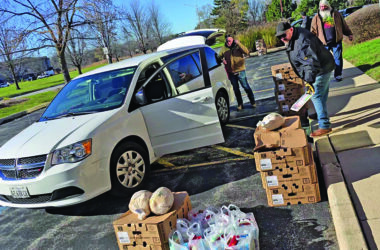 Nick Koster, center, helps voluteers load Thanksgiving turkeys for delivery in 2024. The birds are part of a complete holiday meal provided by Suburban Access Outreach every year to families in need. (Chronicle file photo)