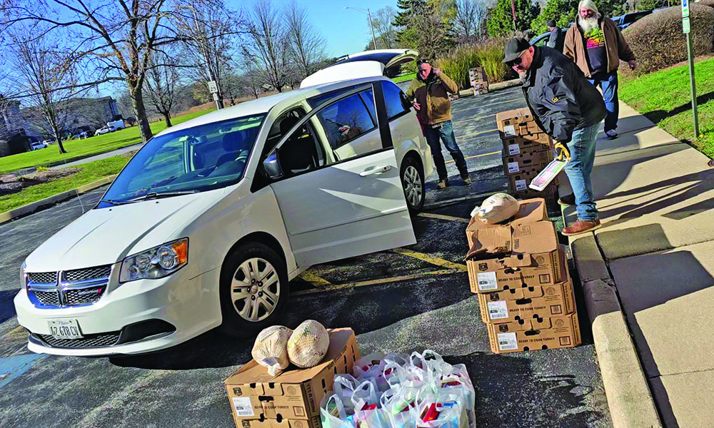 Nick Koster, center, helps voluteers load Thanksgiving turkeys for delivery in 2024. The birds are part of a complete holiday meal provided by Suburban Access Outreach every year to families in need. (Chronicle file photo)