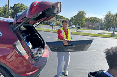 Isaiah Cole, a member of the Homewood-Flossmoor High Key Club, takes a TV for collection during Flossmoor's Recyclepalooza event Sept. 27. (Marilyn Thomas/H-F Chronicle)