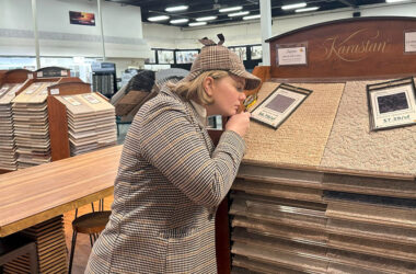 Sherlock’s Carpet & Tile marketing director Marie Sherlock dresses as Sherlock Holmes on the showroom floor as the business celebrates its 50th anniversary. (Provided photo)