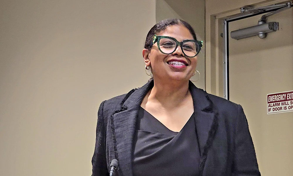 Tenia Davis, owner of Beyond the Book, explains her plans for the new book store in downtown Homewood to trustees and residents at the Aug. 26 board meeting. (Eric Crump/H-F Chronicle)