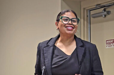 Tenia Davis, owner of Beyond the Book, explains her plans for the new book store in downtown Homewood to trustees and residents at the Aug. 26 board meeting. (Eric Crump/H-F Chronicle)