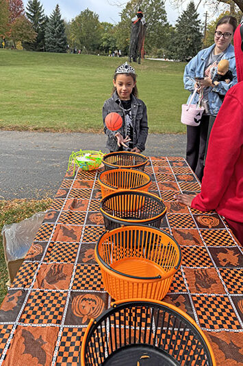 Naliya Banks, 6, makes a bucket at the Monster Buckets game at Trick or Treat Trail on Saturday, Oct. 25. (Marilyn Thomas/H-F Chronicle)