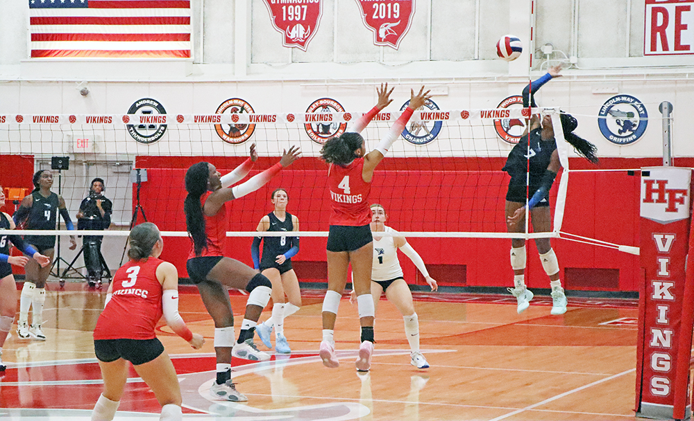 Right-side hitter/setter Naimah Calhoun (4) and middle blocker Ihuoma Ozoh (7) rise for a block to slow the Griffins’ attack during the second set. (Benjamin Faoro/HF Chronicle)