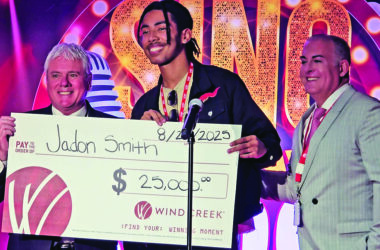Jadon Smith, center, accepts a $25,000 display check from Wind Creek Casino General Manager Roger Kuehn, left, and Wind Creek Chief Operating Officer Brent Pinkston, right. Smith placed second in the casino's Sing Your Way to $100K contest. (Eric Crump/H-F Chronicle)
