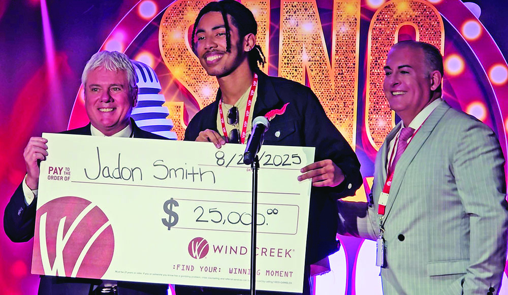 Jadon Smith, center, accepts a $25,000 display check from Wind Creek Casino General Manager Roger Kuehn, left, and Wind Creek Chief Operating Officer Brent Pinkston, right. Smith placed second in the casino's Sing Your Way to $100K contest. (Eric Crump/H-F Chronicle)