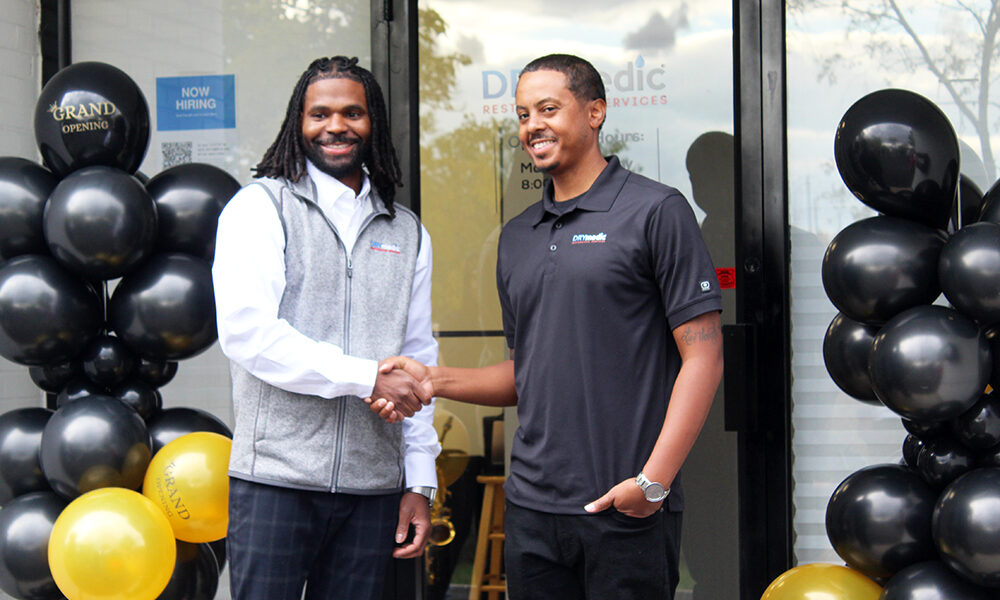 Charles Cathey III and Lance Jones II, of DRYmedic Restoration Services of Homewood, shake hands outside their new office at 1131 175th St. in Homewood. (Nuha Abdessalam/H-F Chronicle)