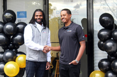 Charles Cathey III and Lance Jones II, of DRYmedic Restoration Services of Homewood, shake hands outside their new office at 1131 175th St. in Homewood. (Nuha Abdessalam/H-F Chronicle)